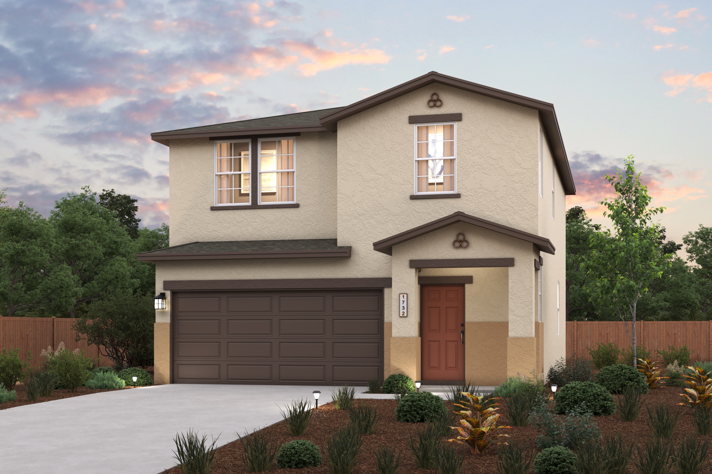 A house with a garage and trees in the back.