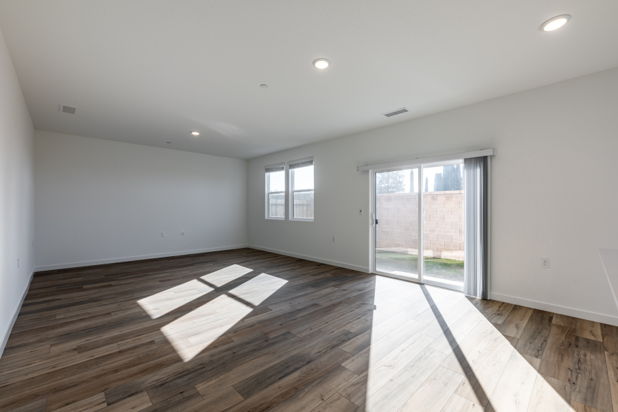 A room with a wood floor and a glass door.