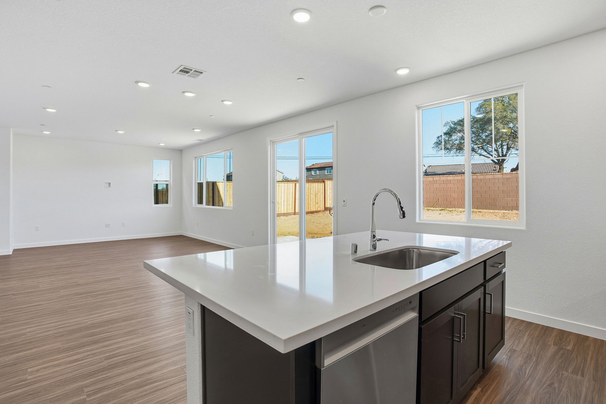 A kitchen with a sink and a large window.