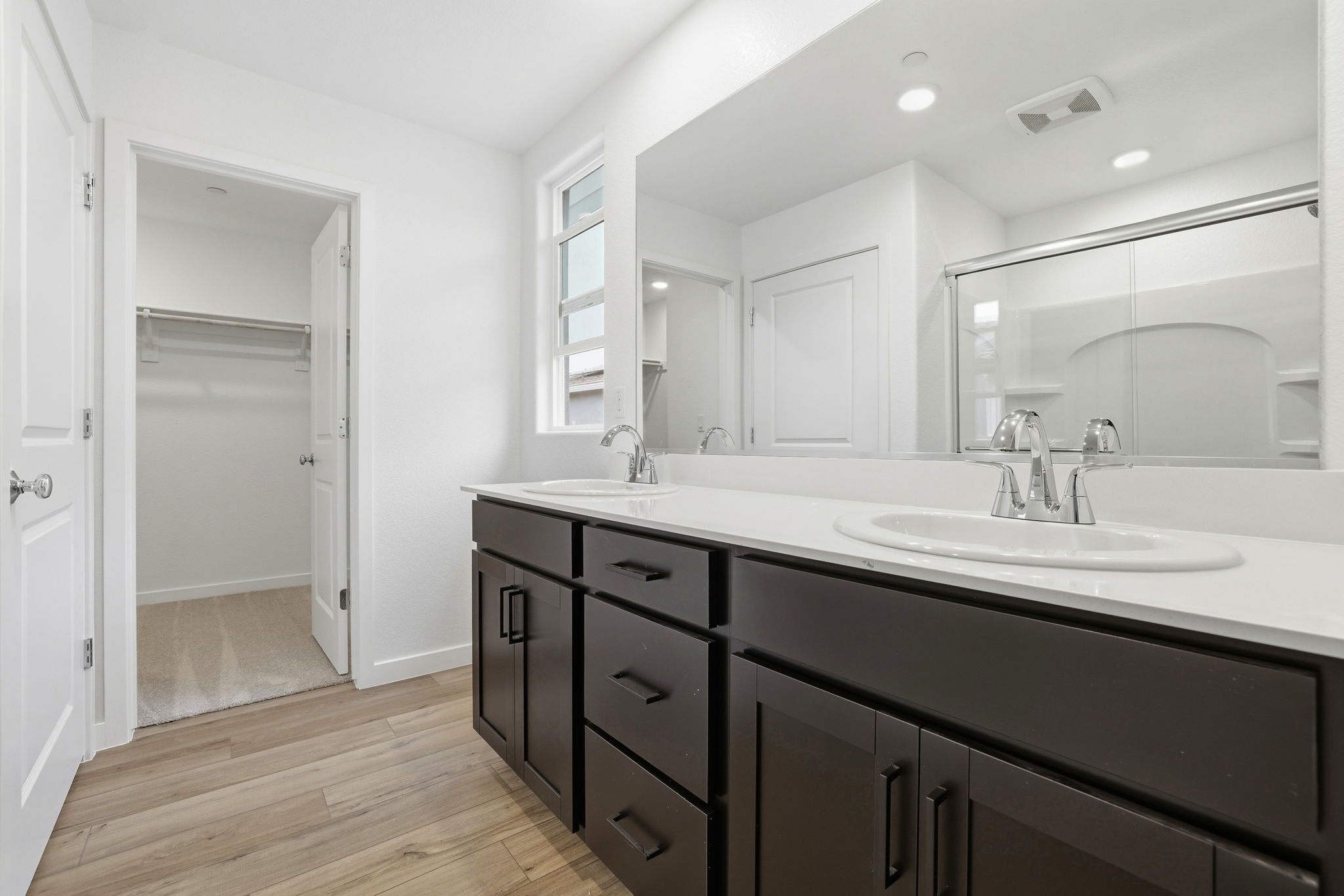 A bathroom with a large mirror.