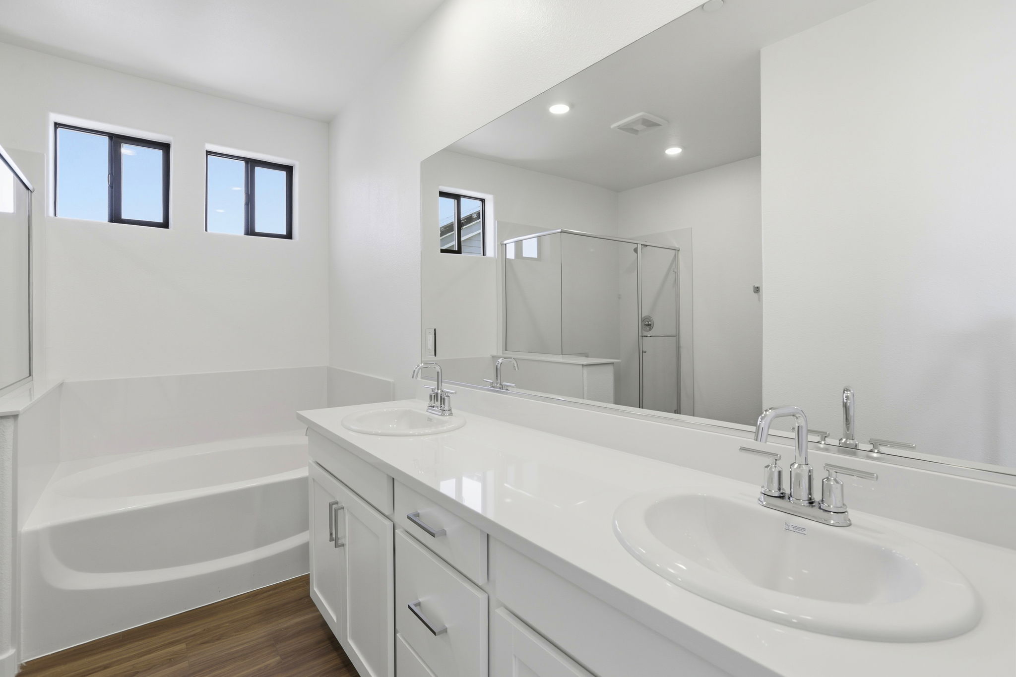 A bathroom with a large mirror.