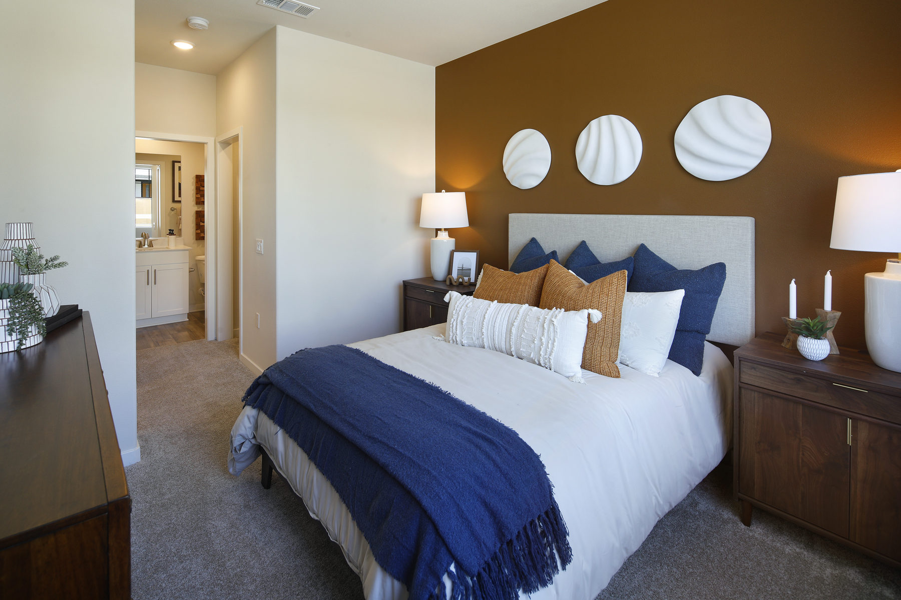 A bed with a blue blanket.