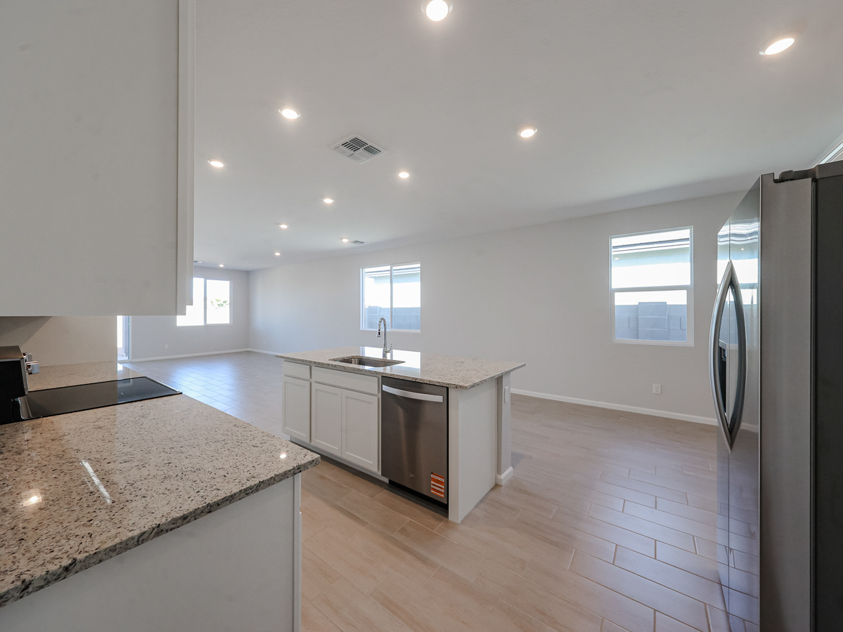 A kitchen with a wood floor.