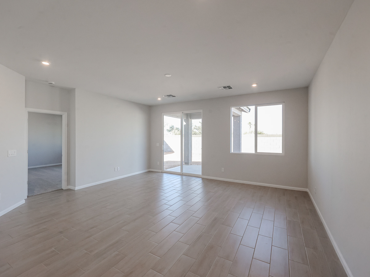 A room with a wood floor and white walls.