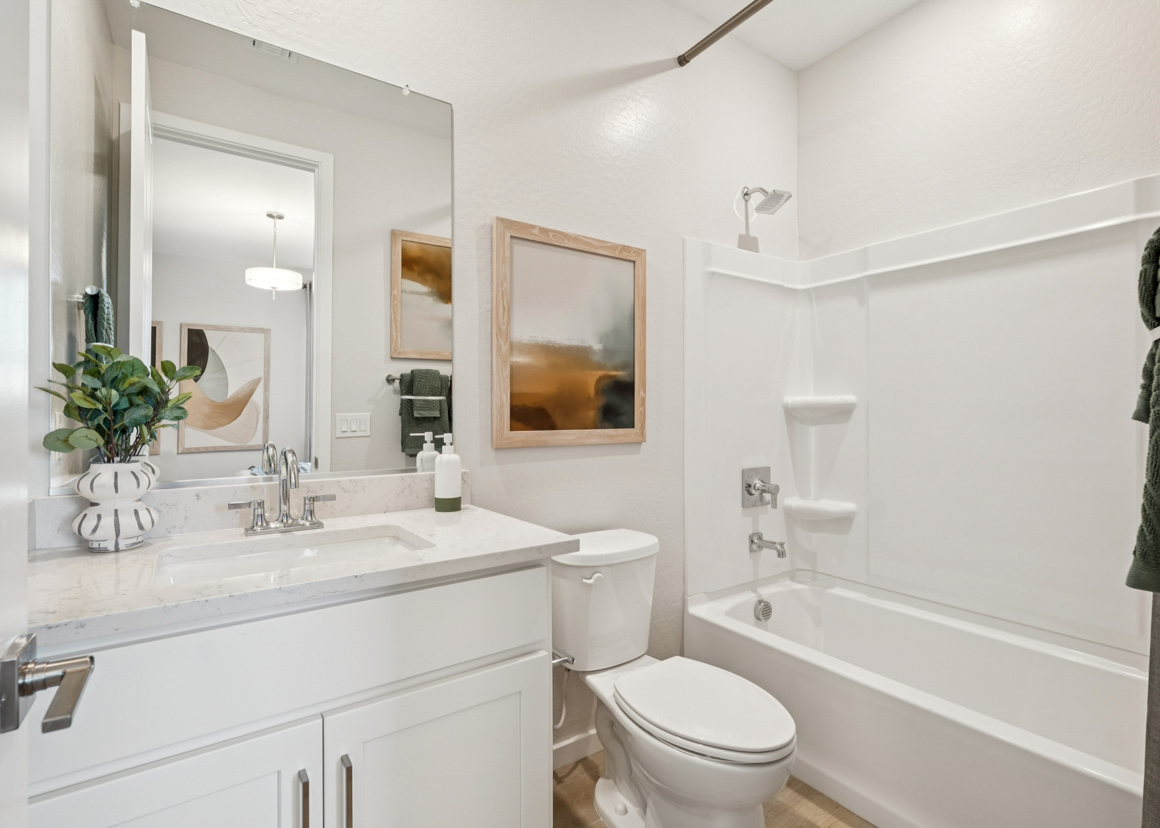 A bathroom with a tub toilet and sink.