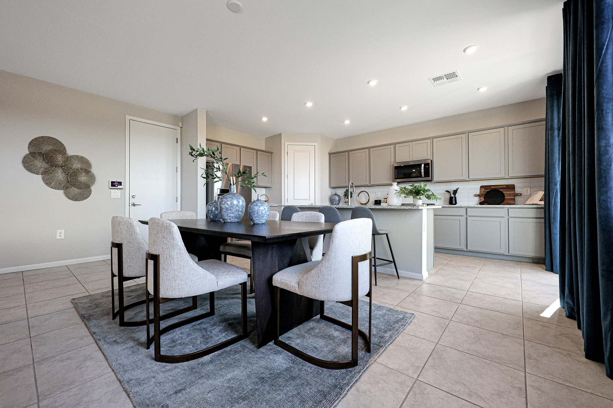 A kitchen with a dining table and chairs.