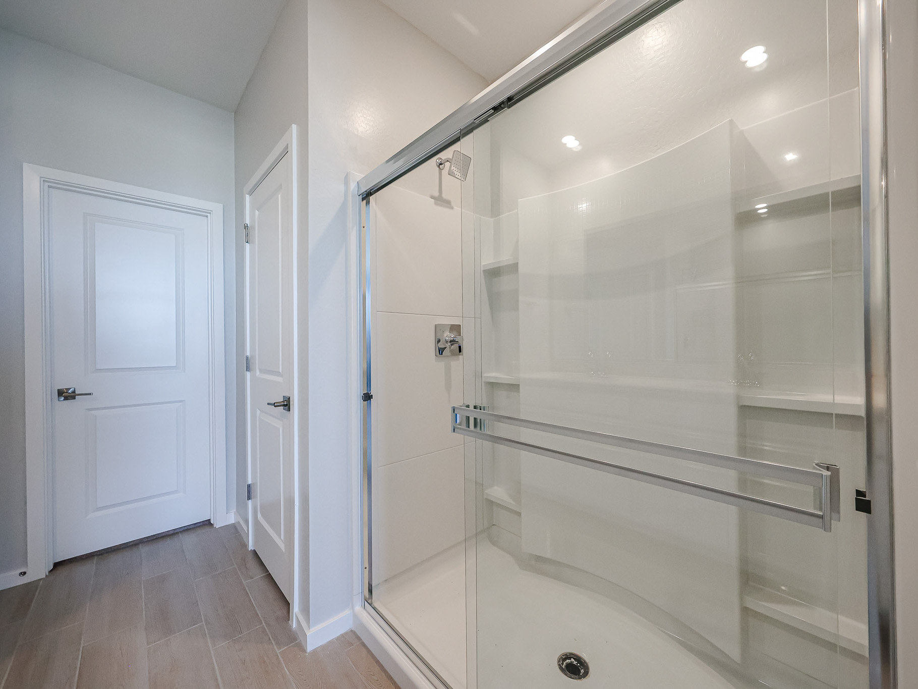 A shower with a glass door.