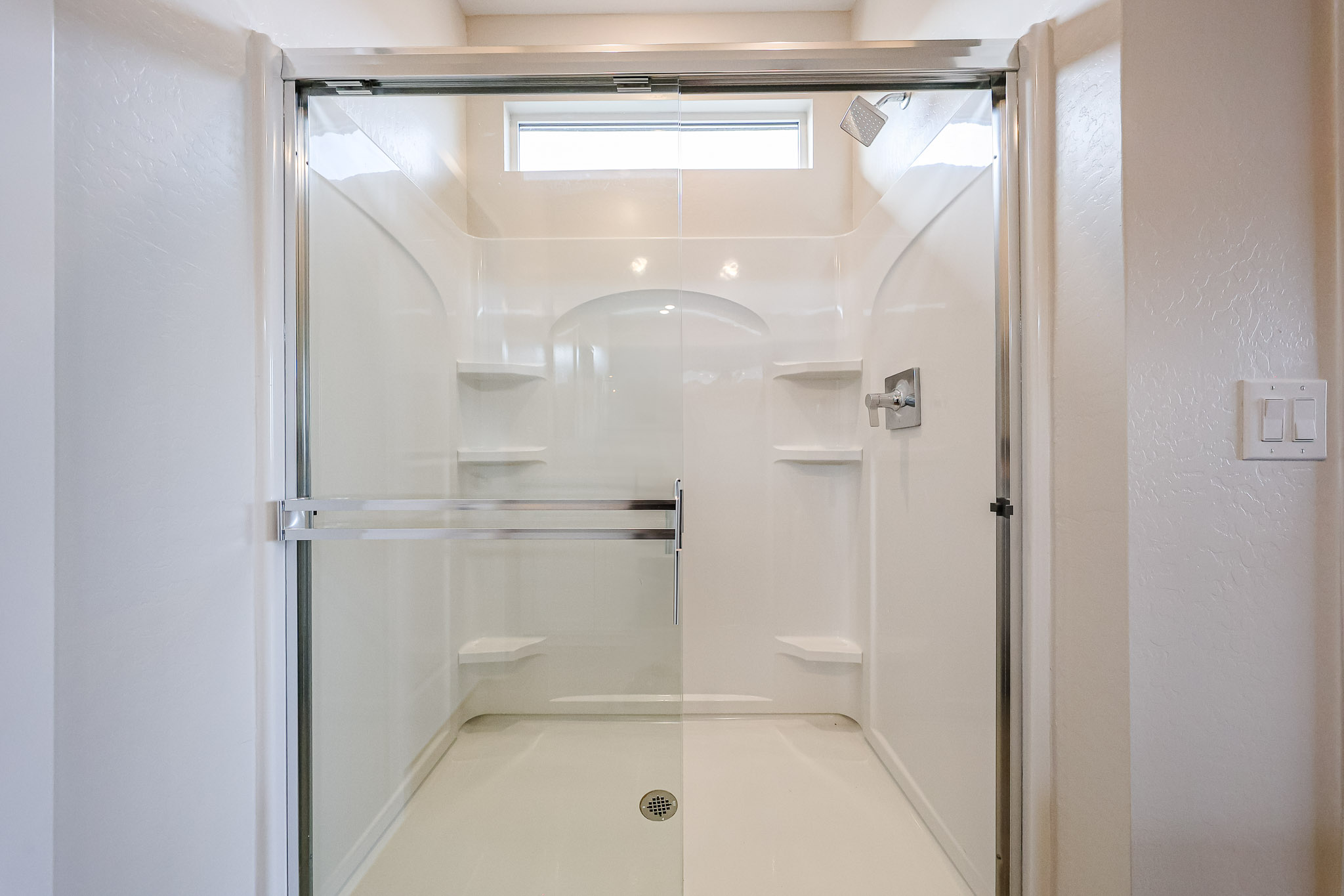 A shower with glass doors.
