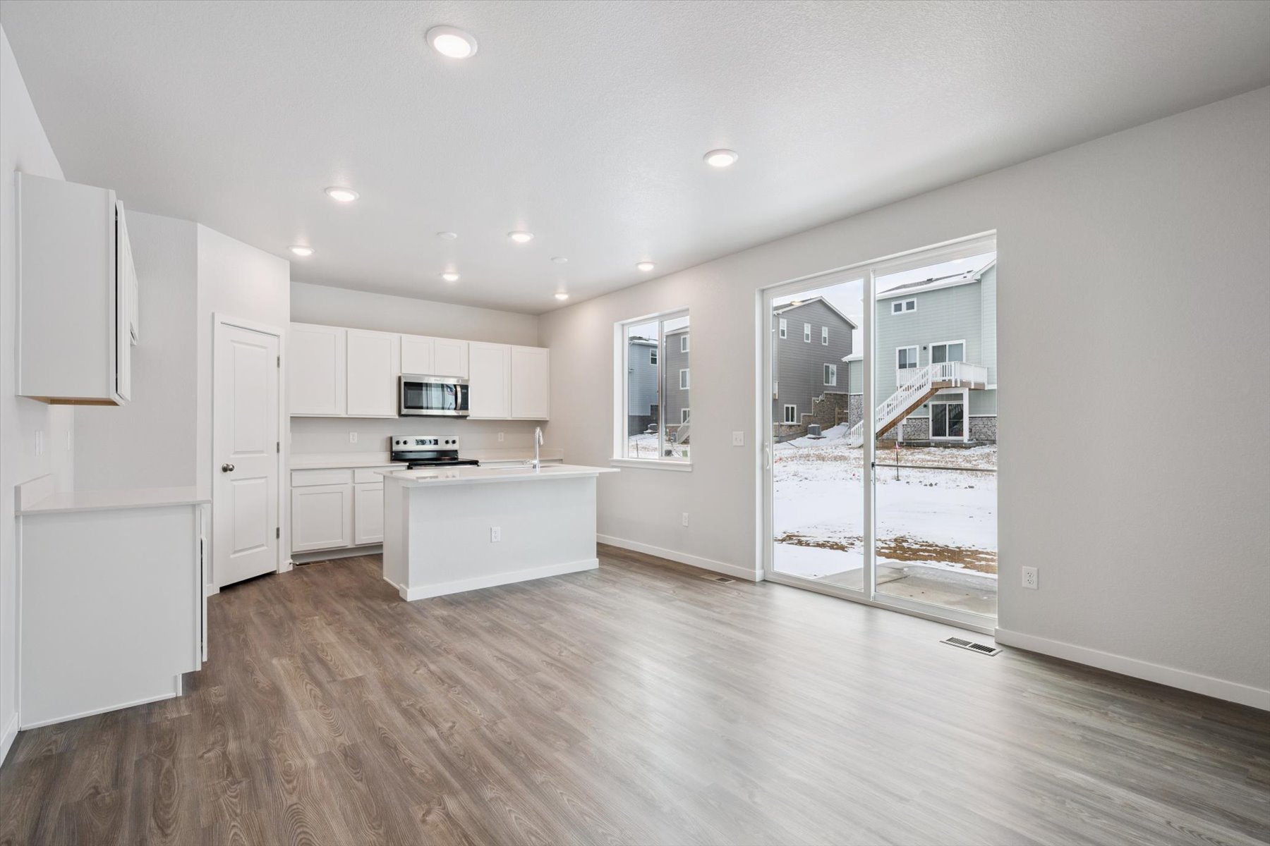 A kitchen with white cabinets.