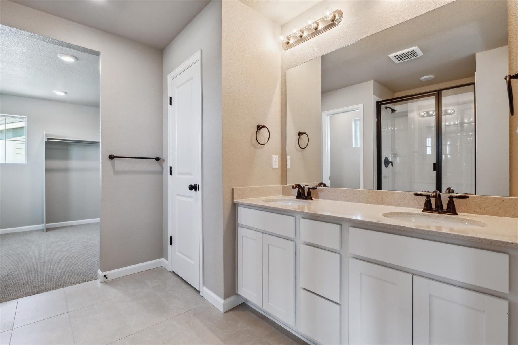 A bathroom with white cabinets.