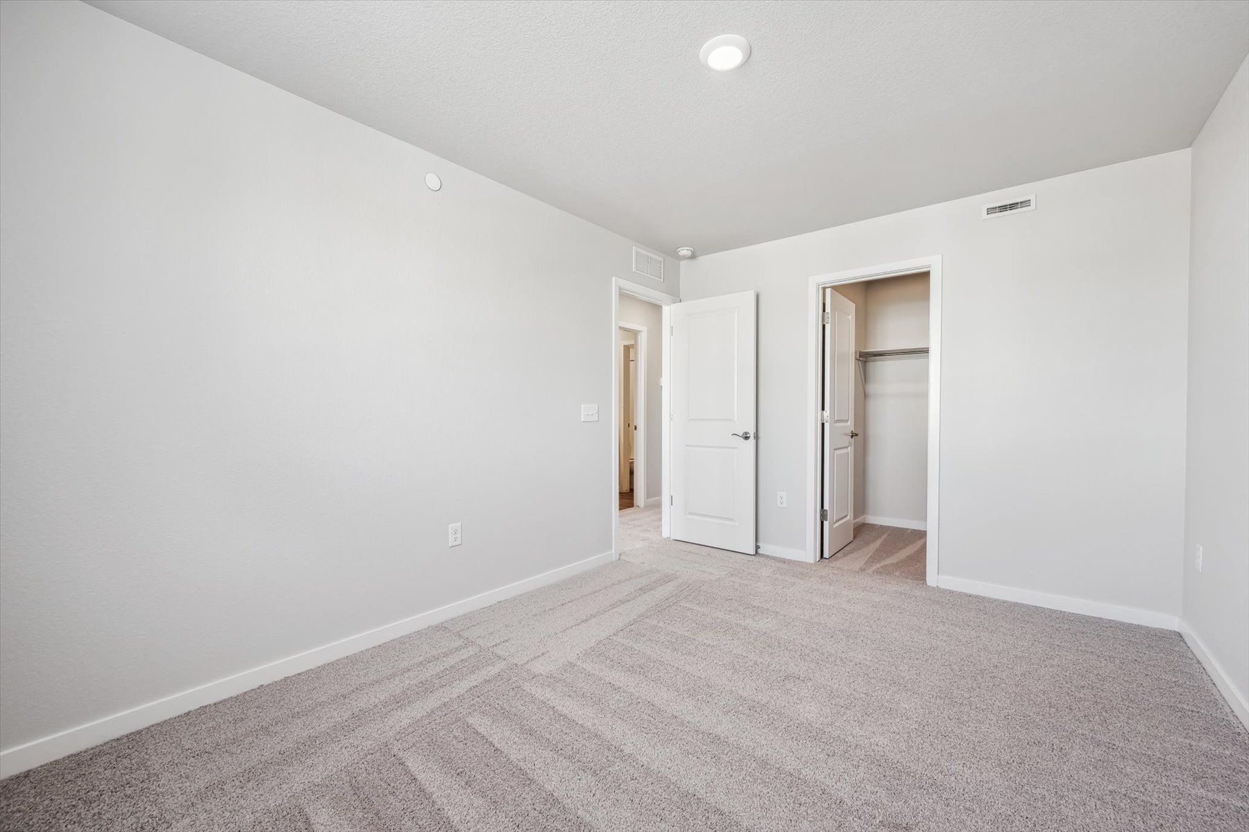 A long hallway with white walls.