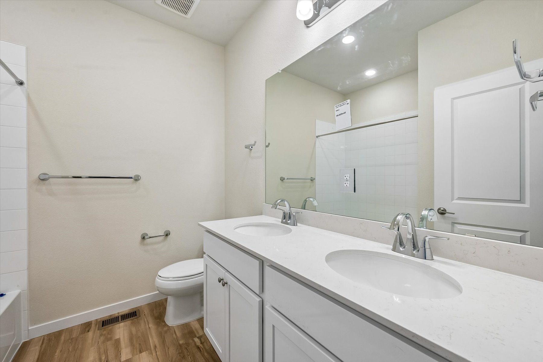 A bathroom with a large mirror.