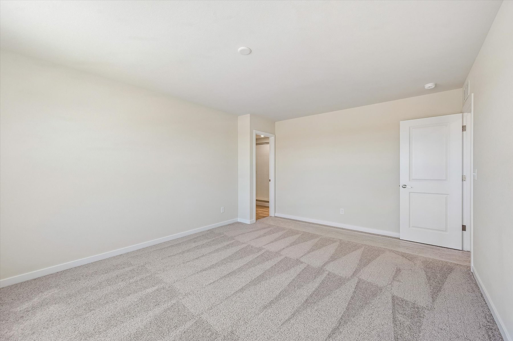 A hallway with white doors.