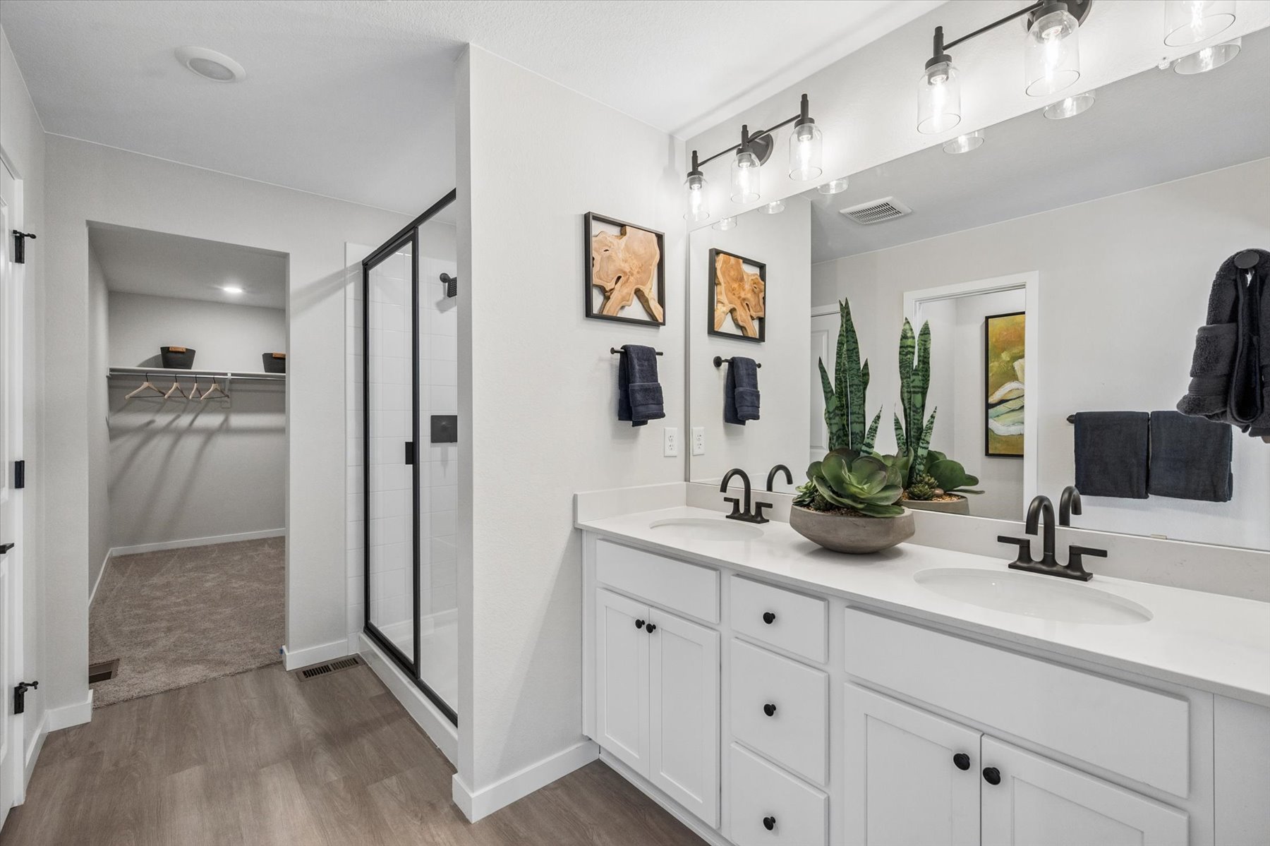 A bathroom with a sink and a shower.