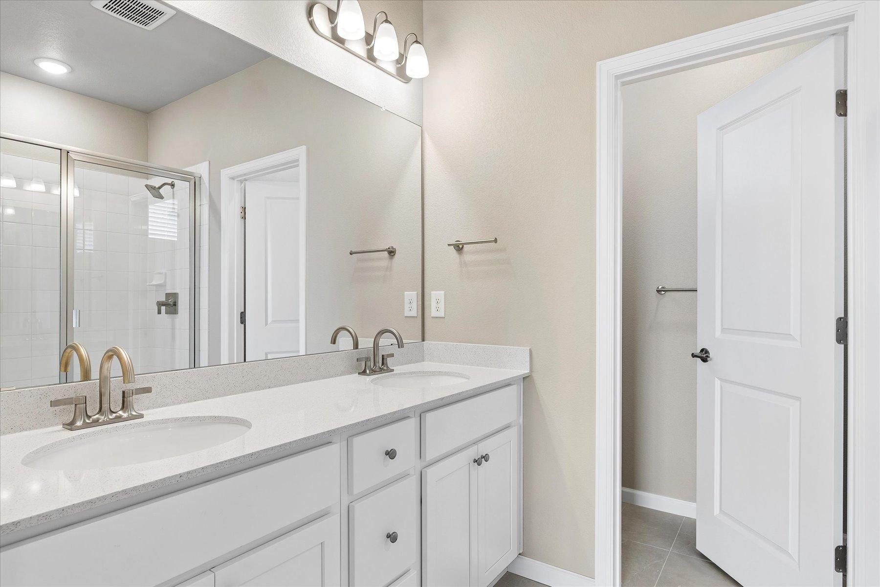 A bathroom with a large mirror.