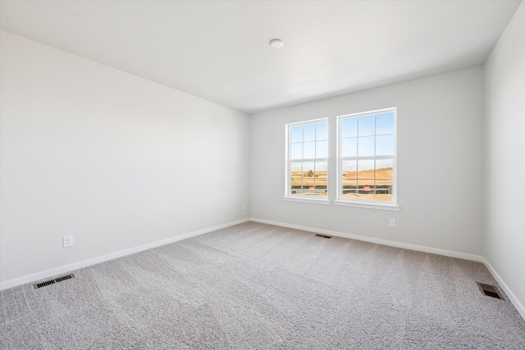 A room with a window and a carpet.