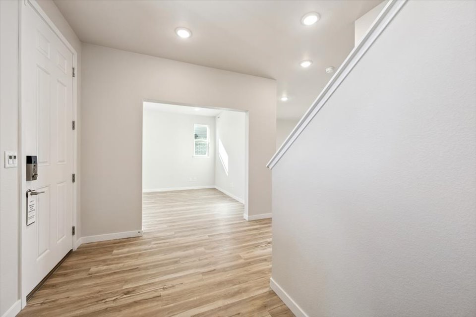 A hallway with white walls.
