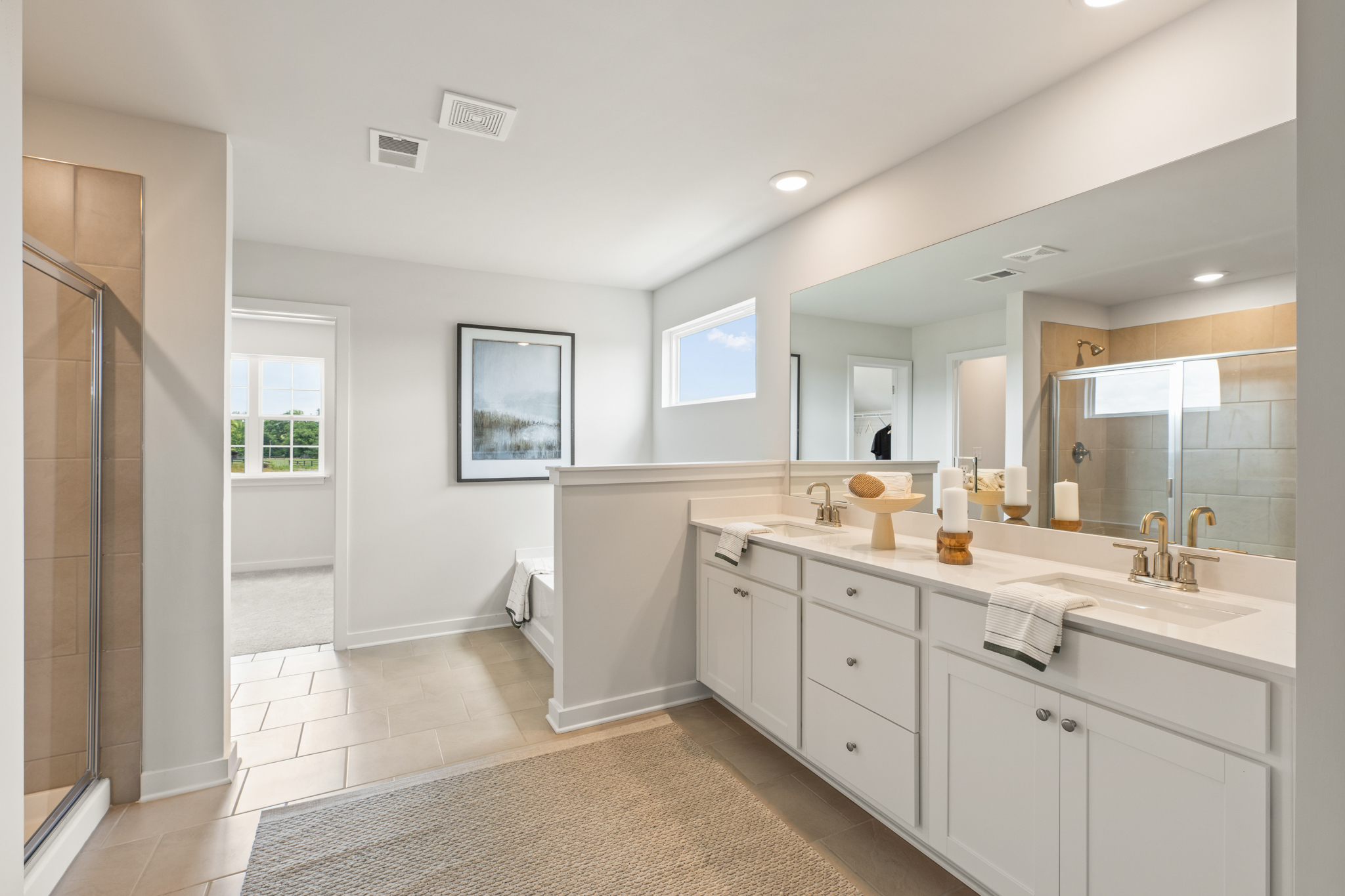 A bathroom with a large mirror.