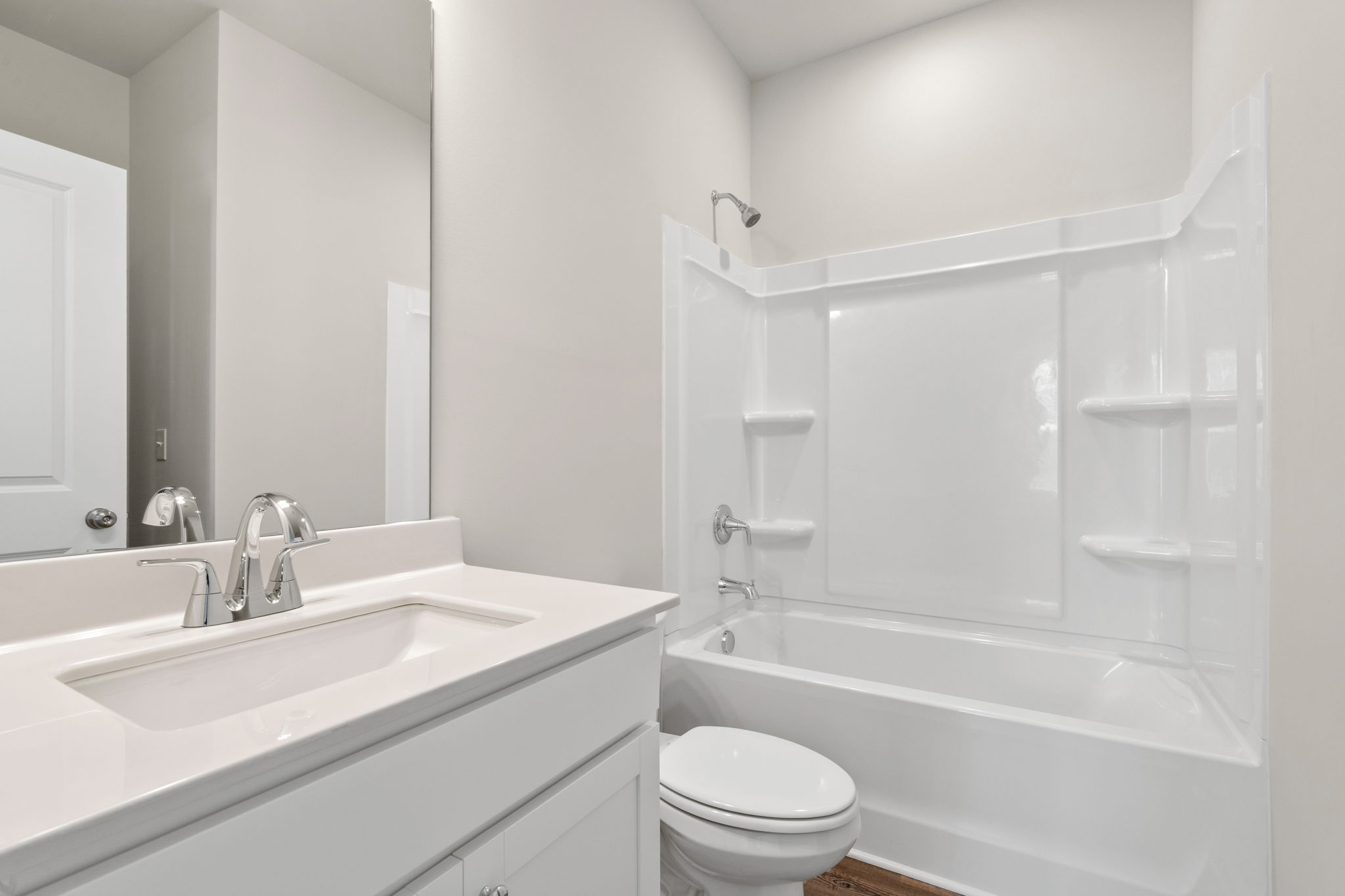 A bathroom with a sink toilet and bathtub.