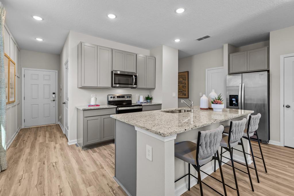 A kitchen with white cabinets.