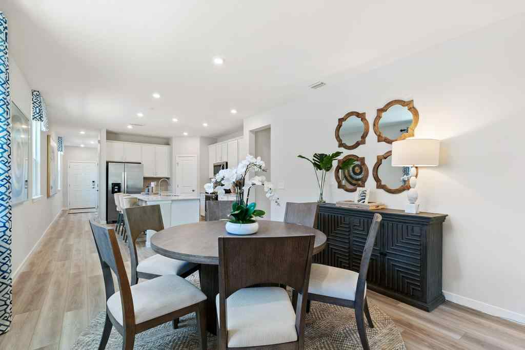 A dining room with a table and chairs.