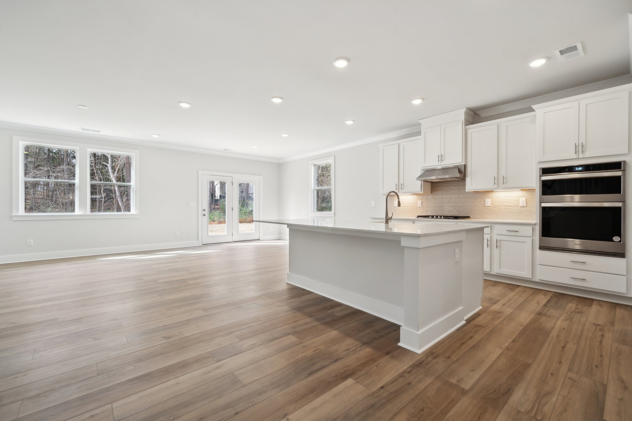 A kitchen with white cabinets.