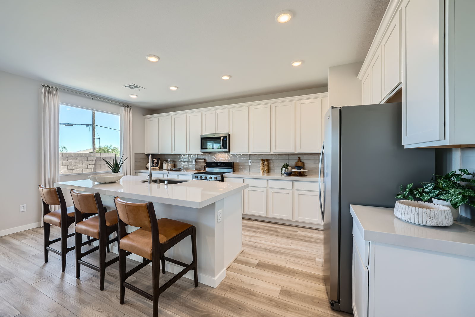 A kitchen with white cabinets.