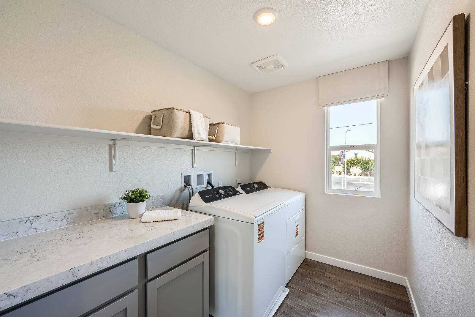 A kitchen with white cabinets.