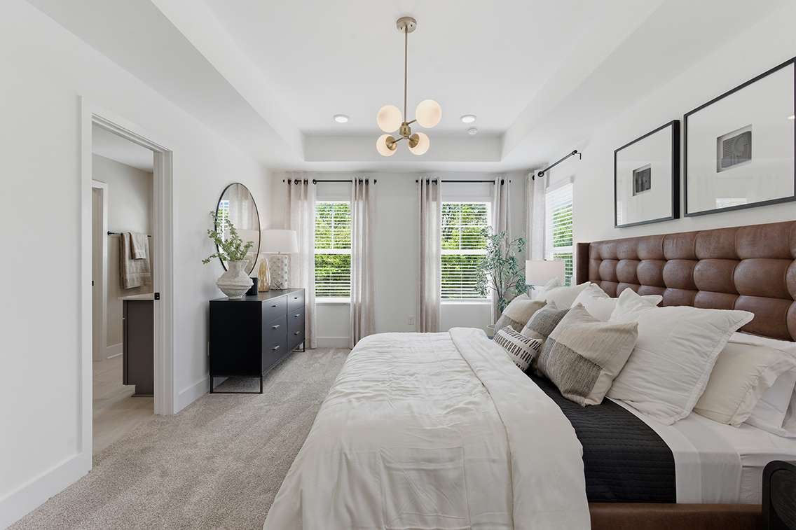 A bedroom with a bed and a couch.