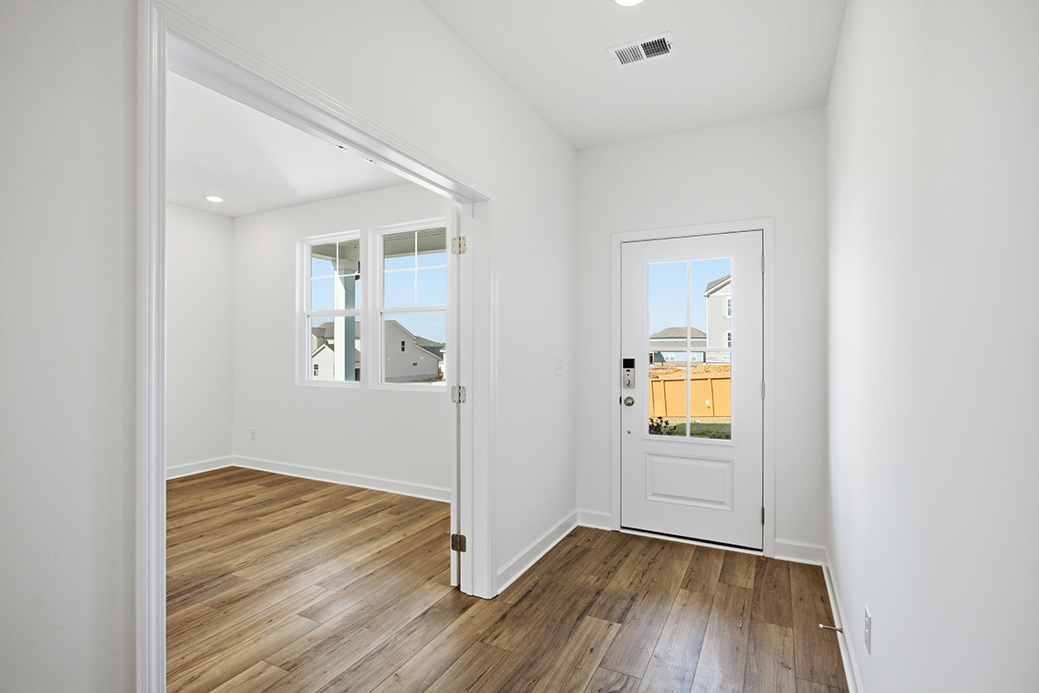 A room with a wood floor and white walls.