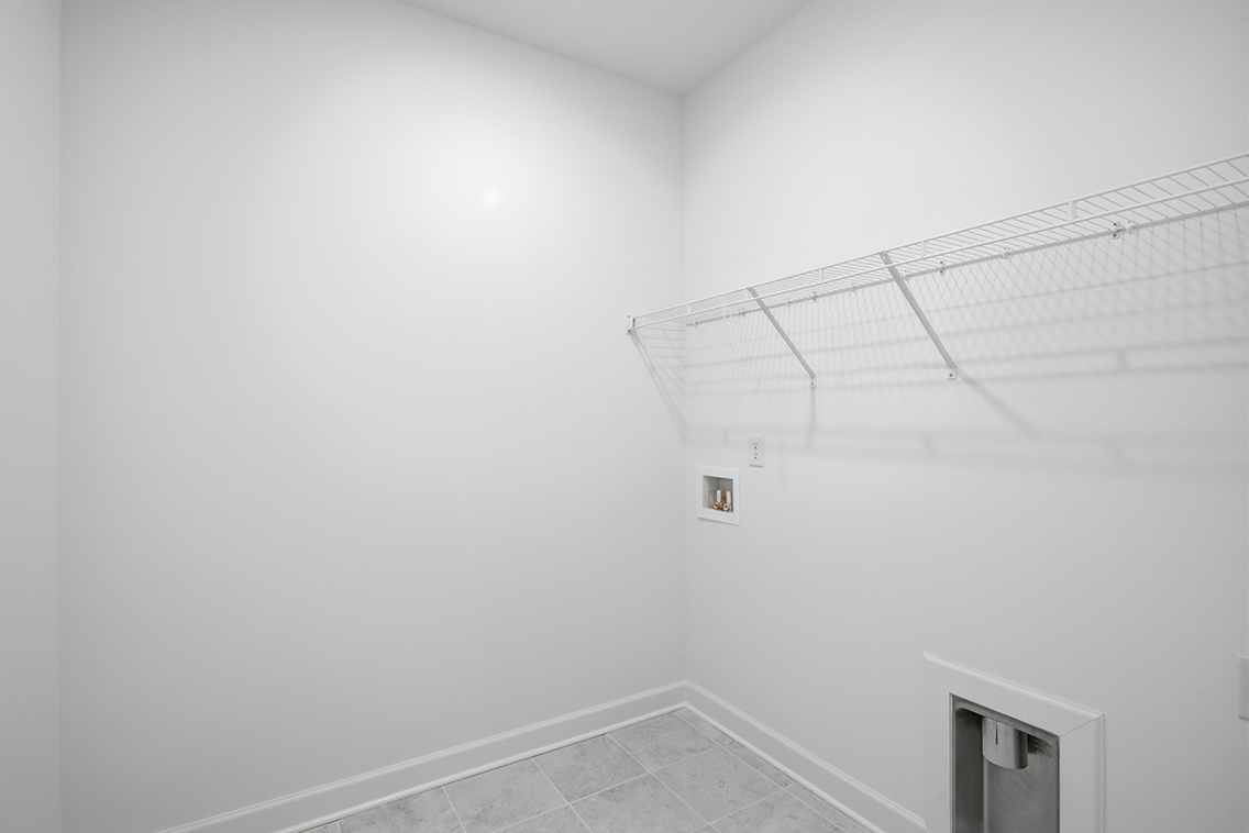 A white room with a tile floor.