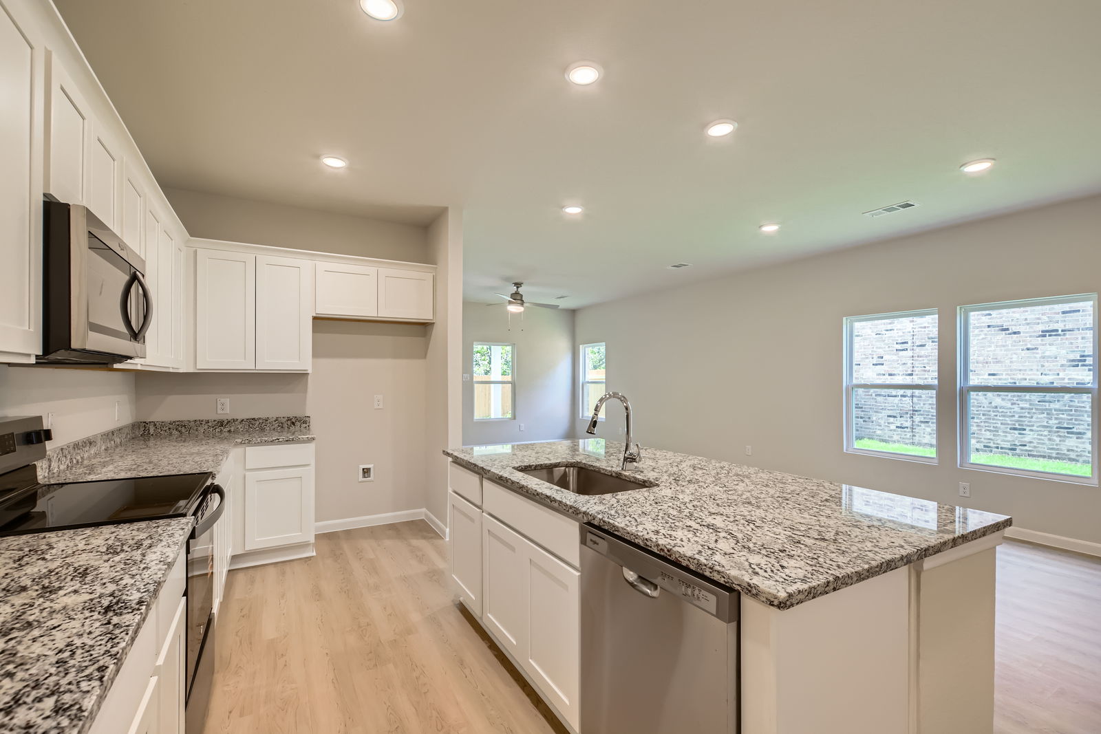 A kitchen with white cabinets.