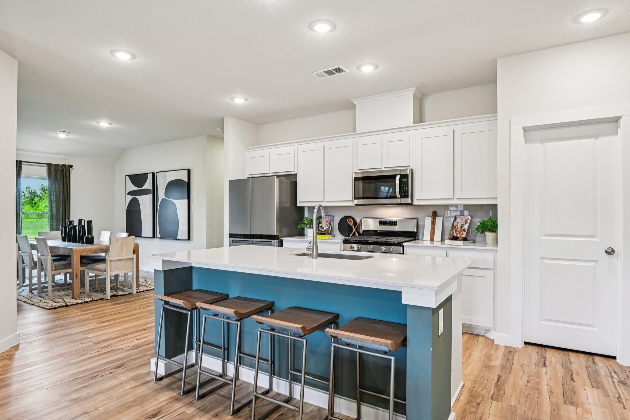 A kitchen with white cabinets.