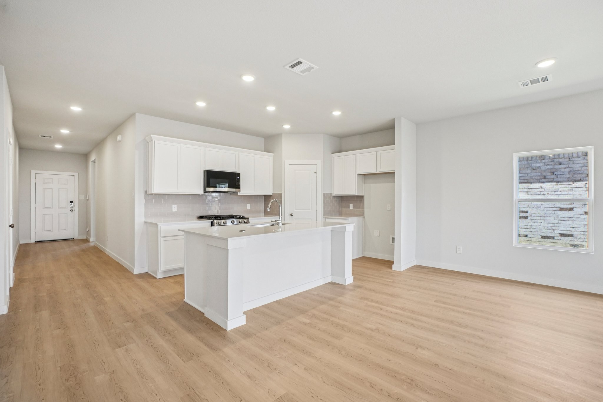 A kitchen with white cabinets.