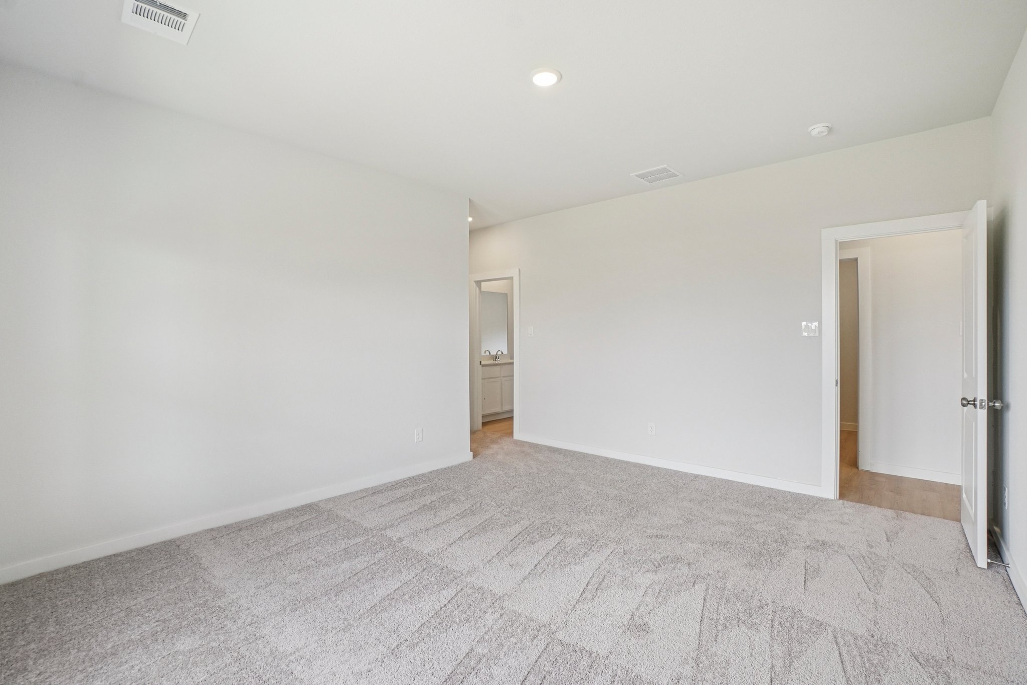 A hallway with white walls.