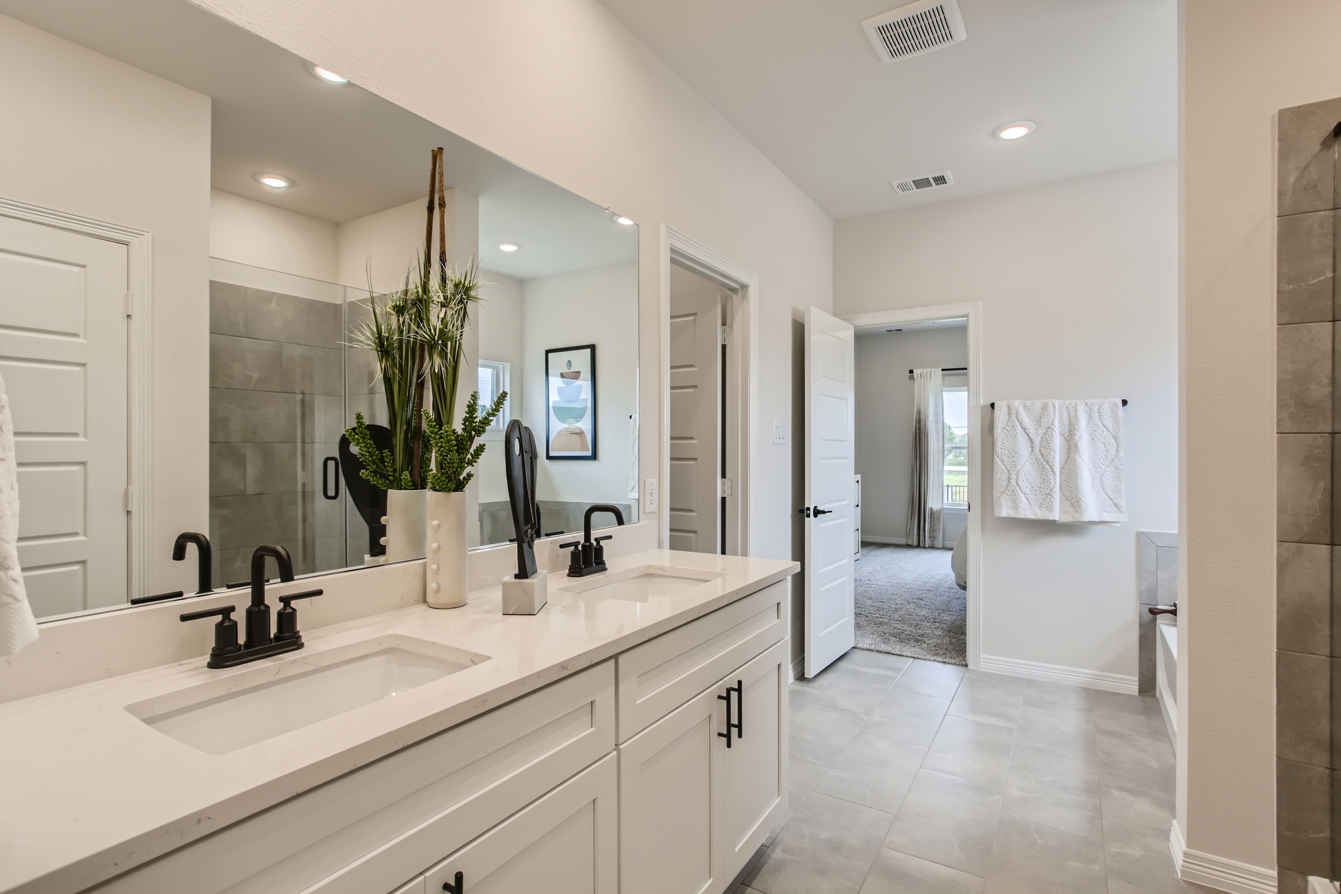 A bathroom with a large mirror.