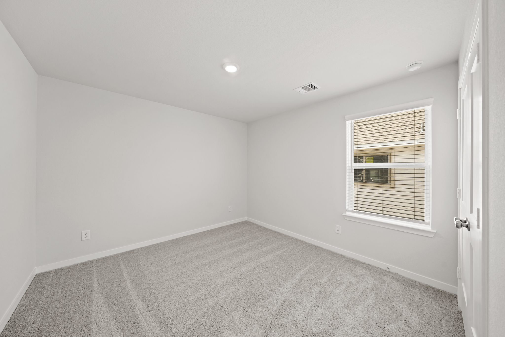 A room with a window and a door.