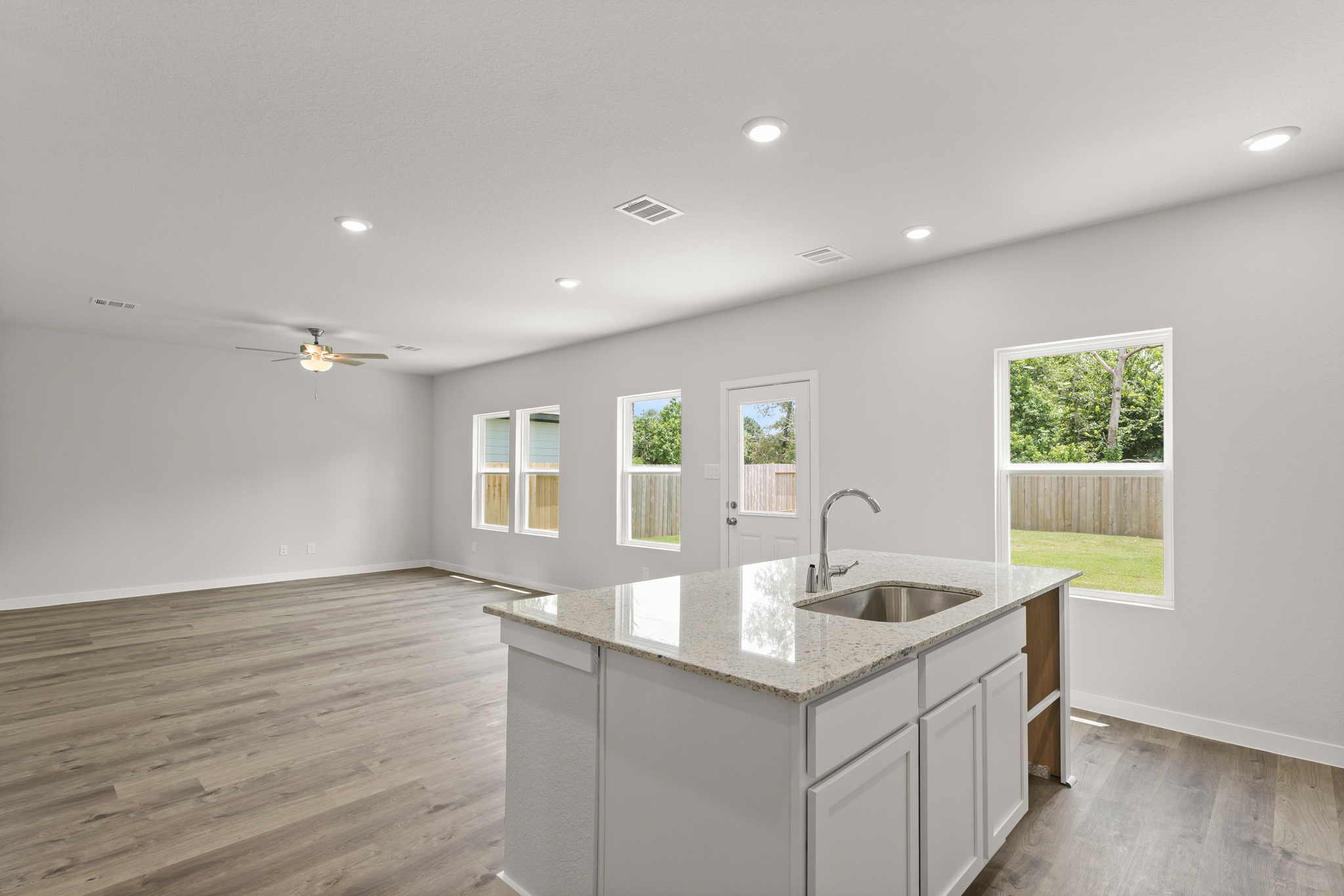A kitchen with a large window.