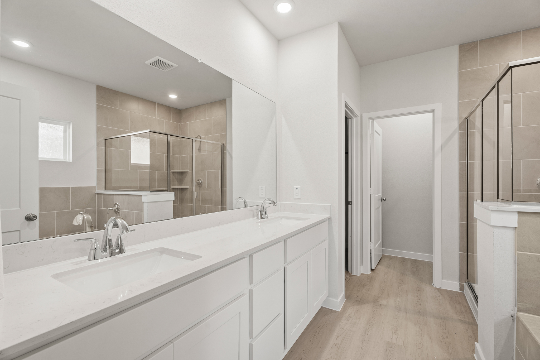 A bathroom with white cabinets.