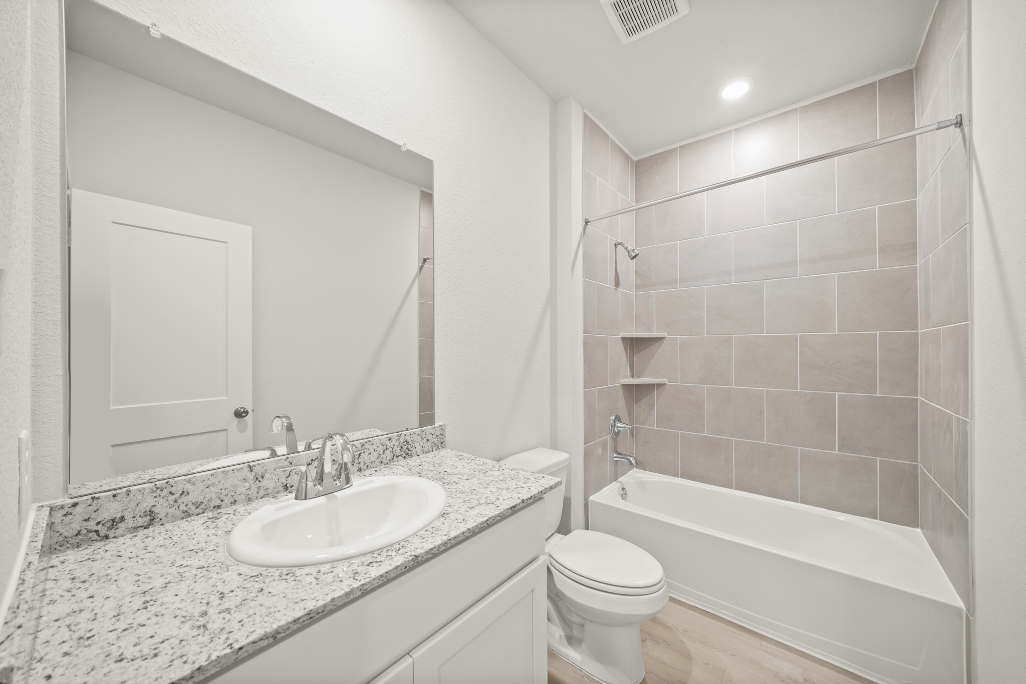 A bathroom with a marble countertop.