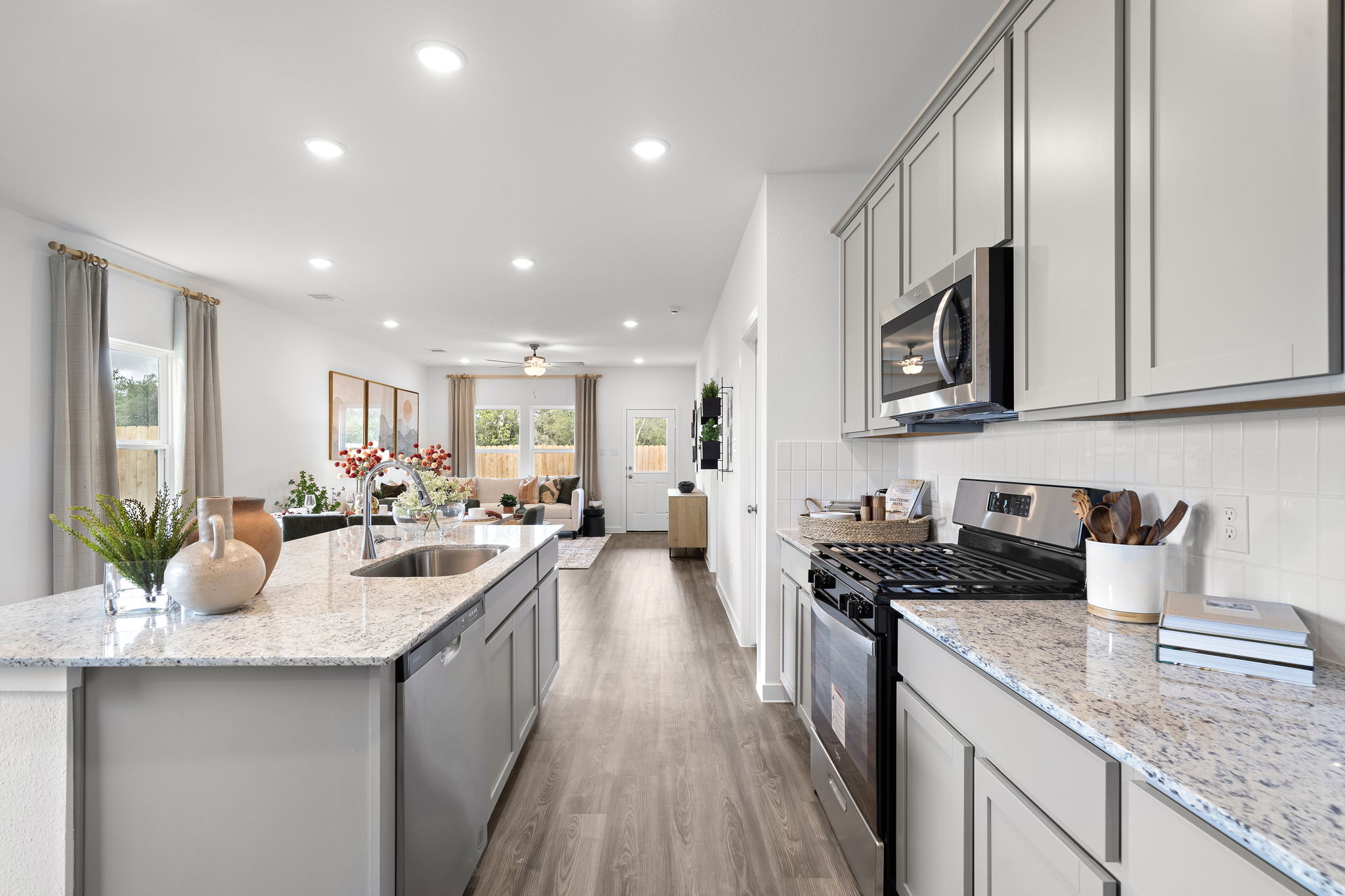 A kitchen with marble counters.