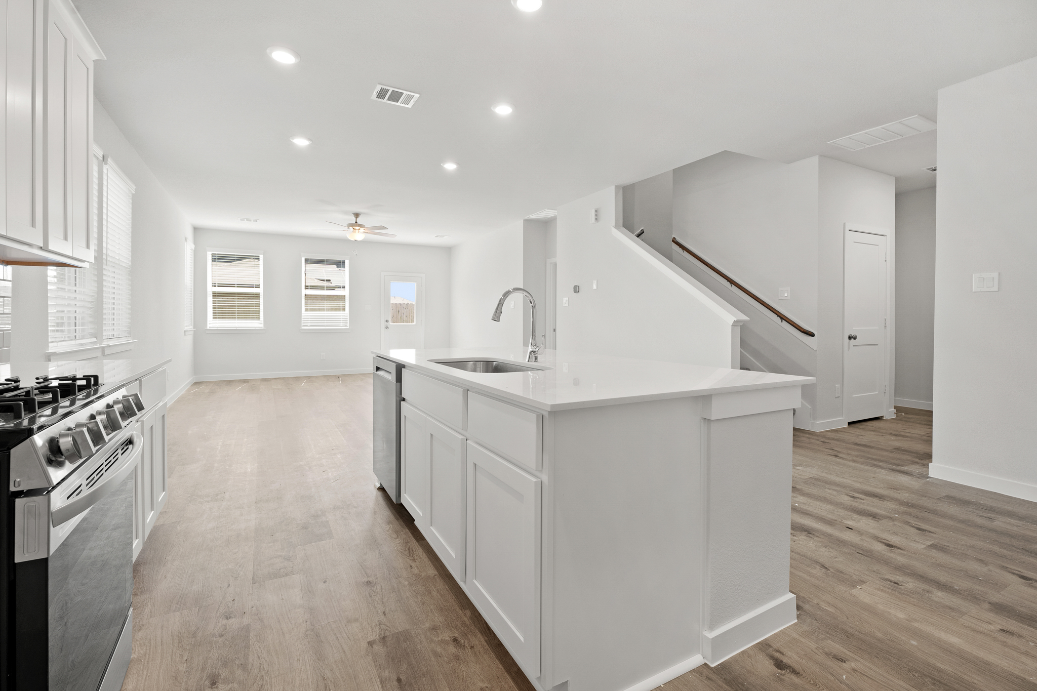 A kitchen with white cabinets.