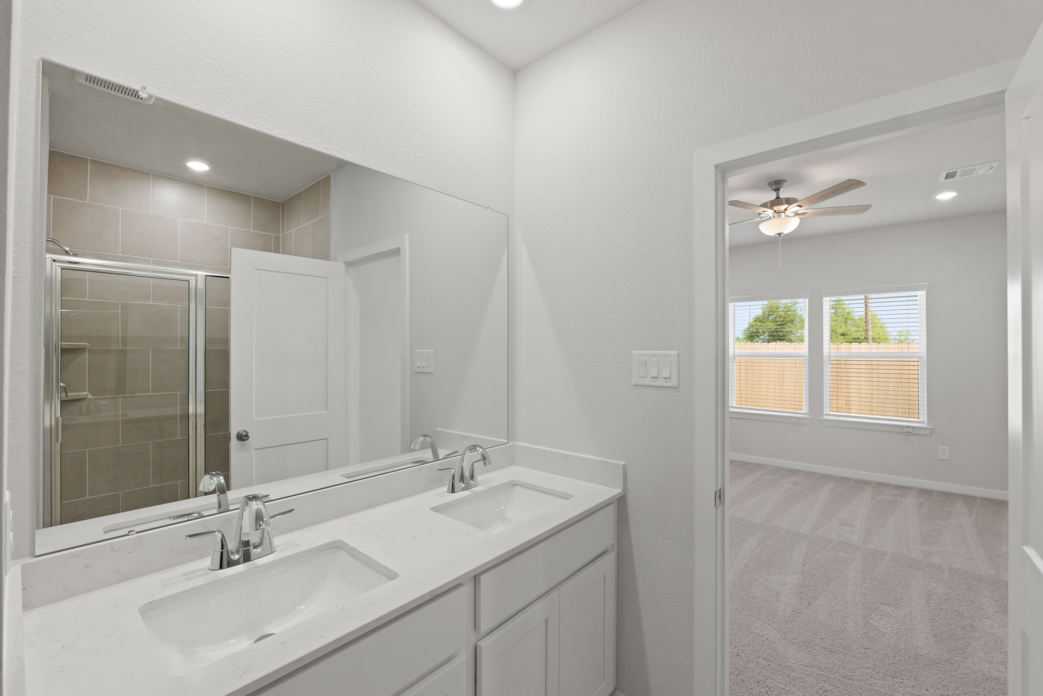 A bathroom with a large mirror.
