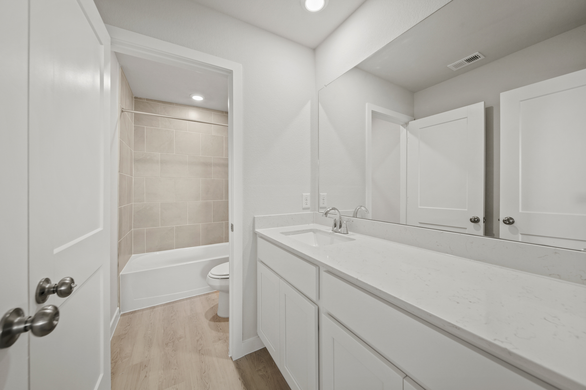 A bathroom with a tub sink and toilet.