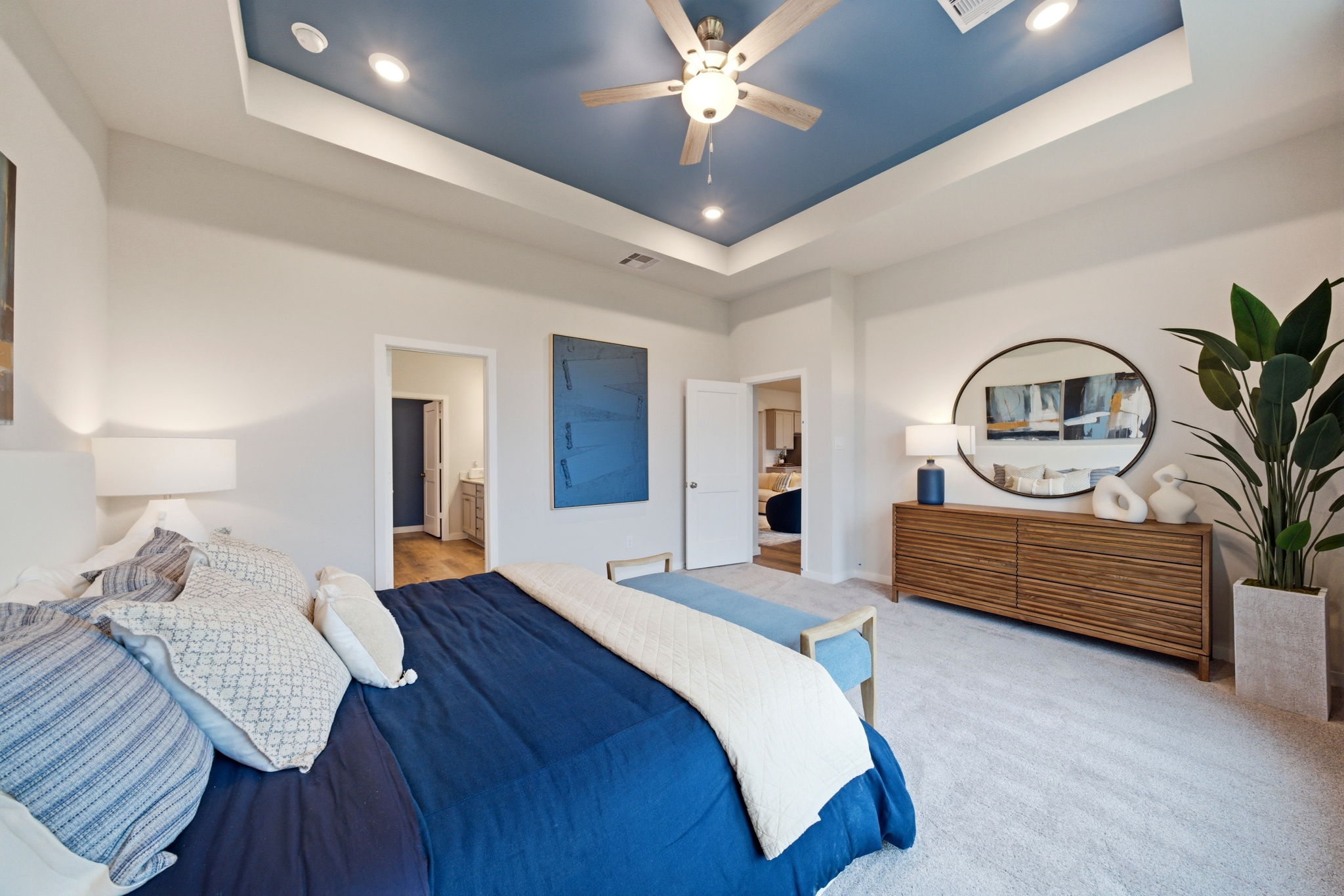 A bedroom with a bed and a fan.