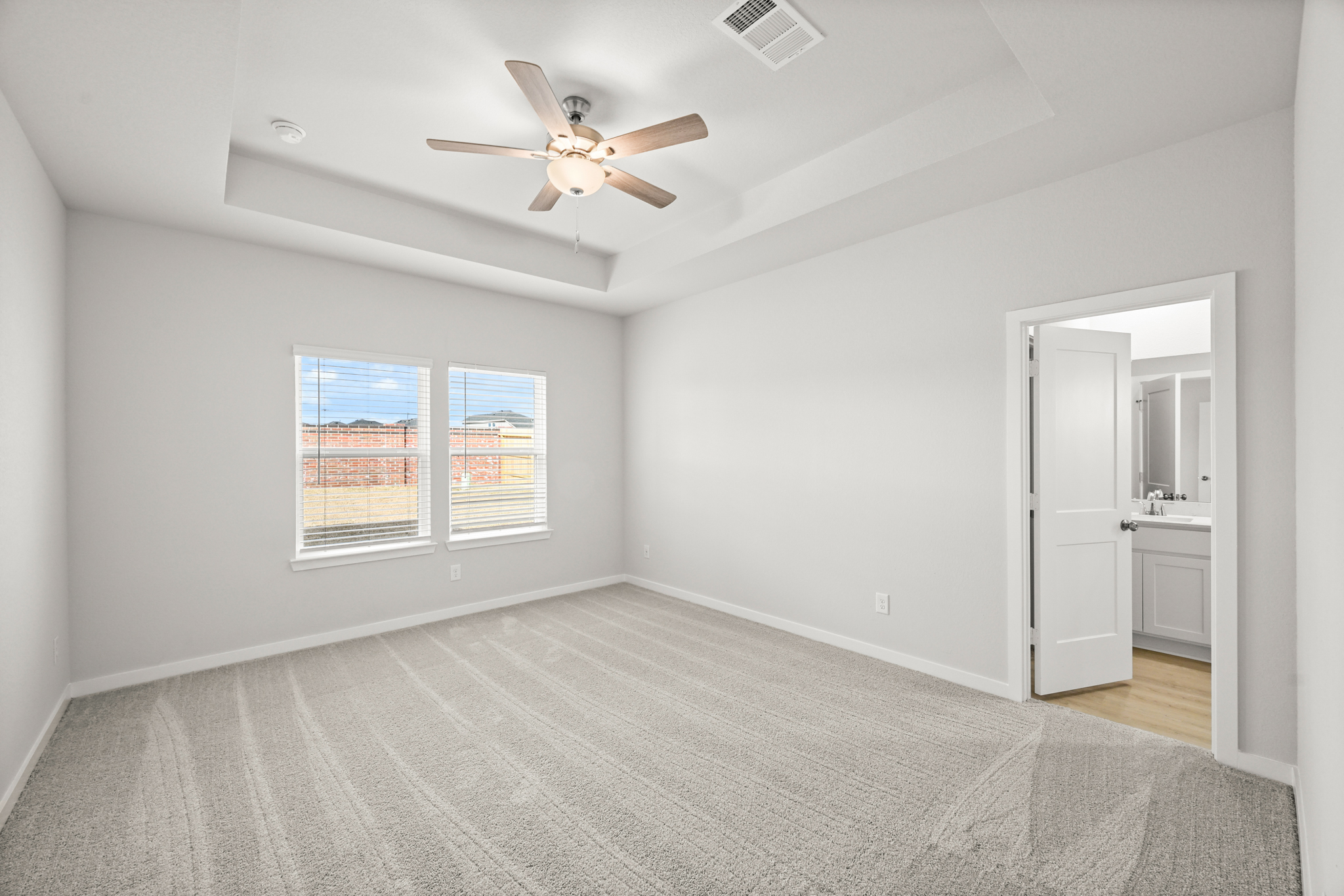 A room with a ceiling fan and a window.