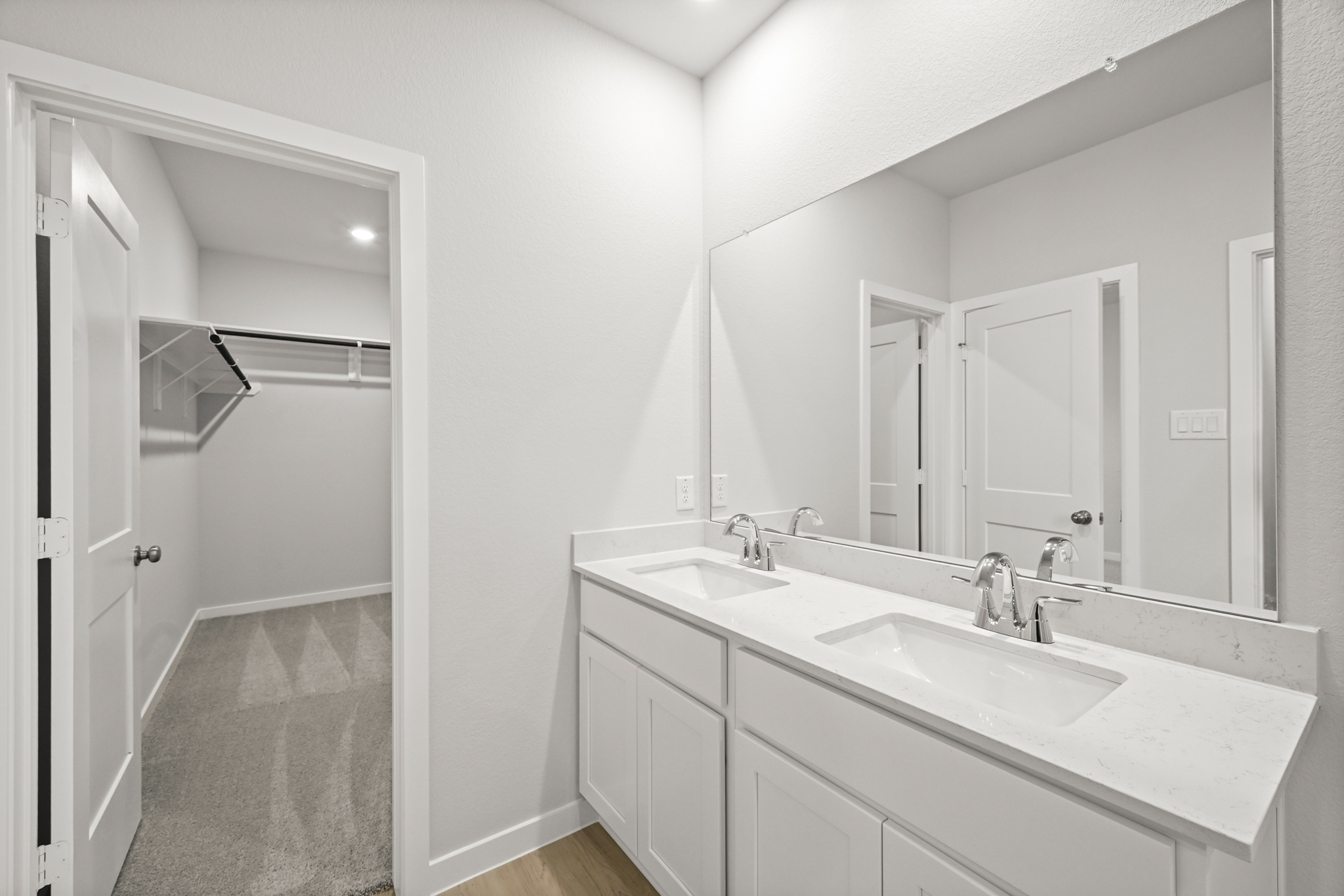 A bathroom with a sink and a shower unit.