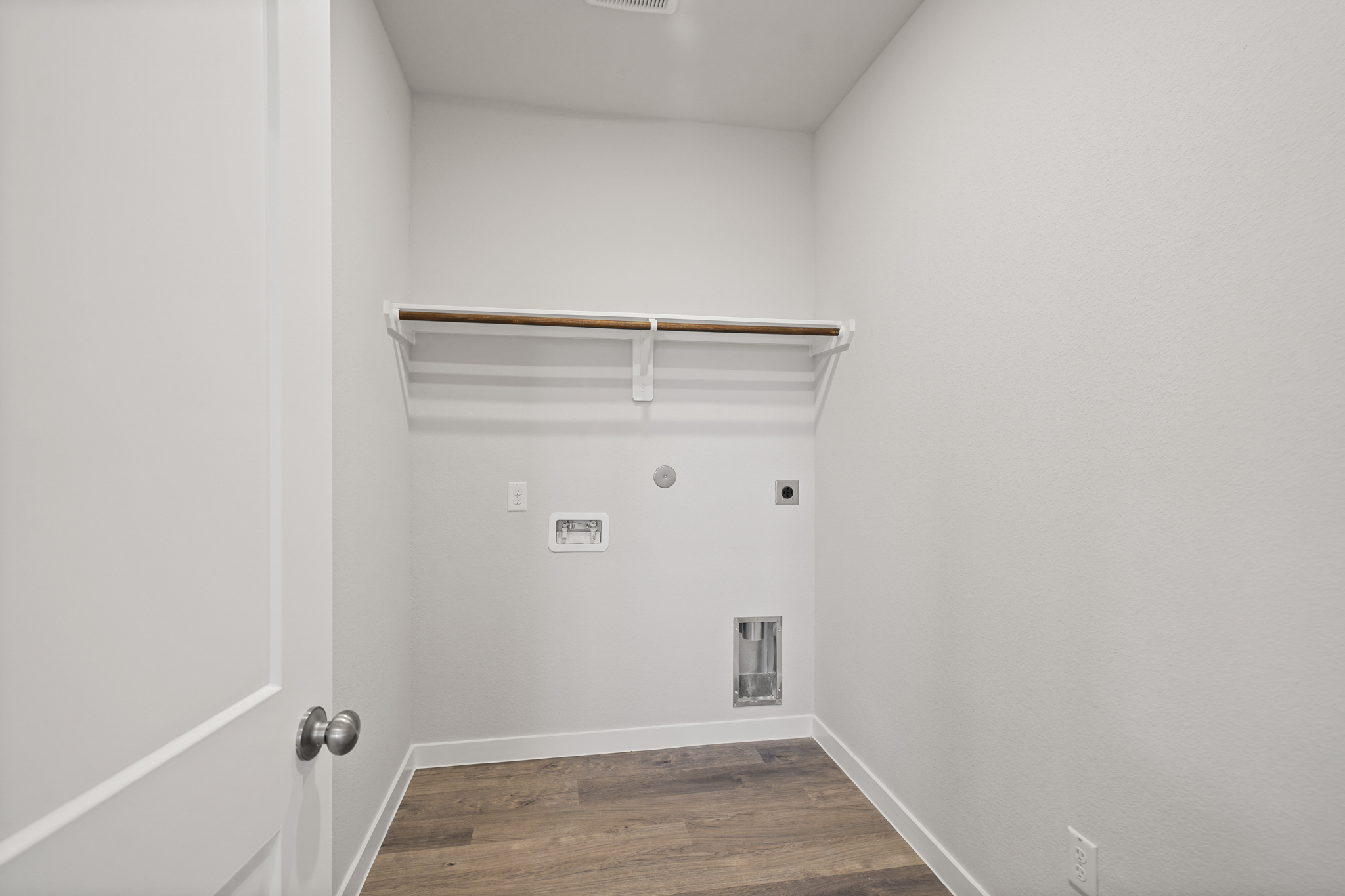 A white room with a wood floor.