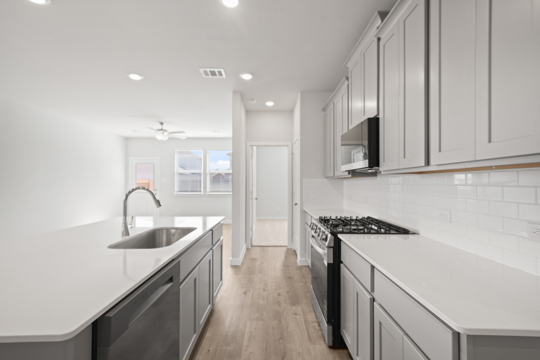 A kitchen with white cabinets.