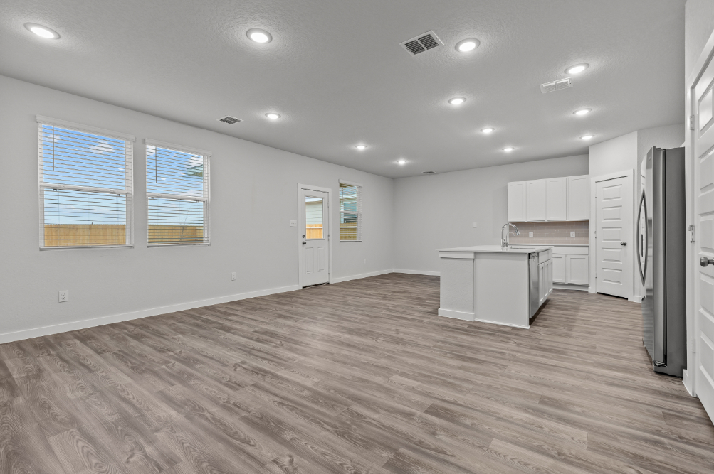 A kitchen with white cabinets.